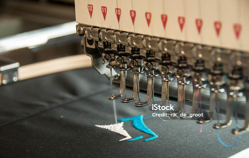 Stick Maschine die gerade ein Poloshirt mit einem blauen und weißes Logo Stick
